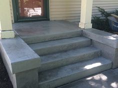 concrete steps leading to the front door of a house