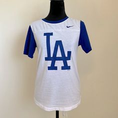 Women Size S Nike La Dodger’s Nike Shirt Brand New White Nike T-shirt For Game Day, Nike Varsity Tops For Game Day, Varsity Blue T-shirt With Text Print, Blue Varsity T-shirt With Text Print, Nike Collegiate Tops With Letter Print, Nike Blue Collegiate T-shirt, Nike Varsity Crew Neck Tops, Nike Crew Neck Tops For College, Blue Casual Tops For Game Day