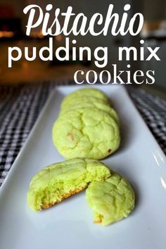 two green cookies on a white plate with the words pistachio pudding mix cookies