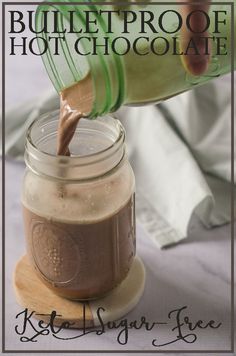 a person pouring chocolate into a mason jar