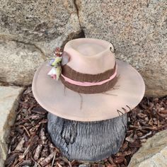 "The Mae is pretty in pink... with beige tones. Simple and pretty is The Mae! Handmade Fedora hats with Western style bling. All hats are ONE OF A KIND and designed personally by myself. Purposely aged to add lots of character! I enjoy creating unique items for others to enjoy in this mass produced world. Be UNIQUE... stand out in the crowd!  All hats are made to fit differently- this hat measures about 23\" with a tie to make adjustments allowing you to tighten the fit." Pink Bohemian Sun Hat For Kentucky Derby, Bohemian Pink Sun Hat For Kentucky Derby, Bohemian Pink Hat Band For Kentucky Derby, Pink Bohemian Fedora Hat, Bohemian Pink Felt Hat With Short Brim, Country Style Pink Beach Hat, Pink Bohemian Sun Hat With Flat Brim, Pink Western Cap Hat, Western Style Pink Cap