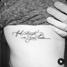 a woman's lower back tattoo with the words, if strength is your power