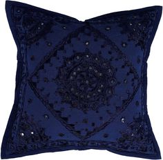 a blue decorative pillow with sequins and beads on the front, sitting on a white surface