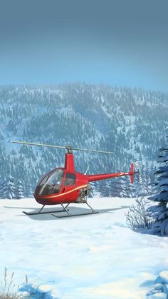 a red helicopter flying over a snow covered forest