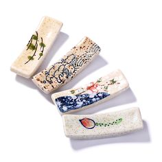 four pieces of ceramic with designs on them