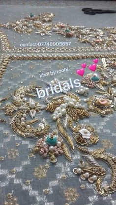 a table topped with lots of different types of brooches and pearls on top of it