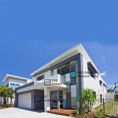 a modern house with lots of windows and landscaping