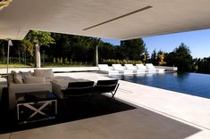 an outdoor living area next to a swimming pool