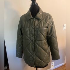 Sz M. Nwt. Olive Green Faux Leather. Very Soft. Quilted Pattern. Barn Style Jacket. Snap Front Closure. Two Front Open Patch Pockets. Measures Approx 21” Across Chest From Armpit To Armpit And 28” (Front) In Length From Top Of Shoulder To Hem. Back Is Approx 31” In Length. Comes From A Smoke Free Home. Casual Quilted Leather Jacket For Spring, Faux Leather Jacket For Spring Cold Weather, Faux Leather Jacket For Spring And Cold Weather, Red Puffer Coat, Faux Suede Vest, Black Quilted Jacket, Beige Trench Coat, Black And White Jacket, Polyester Jacket