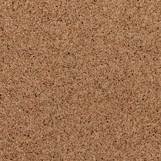 a close up view of the surface of a cork board with brown speckles