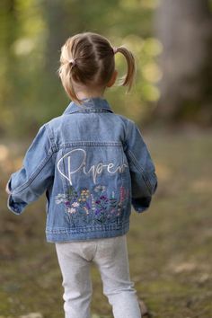 Embroidered Denim Jacket With Wildflowers! Name will be done in blonde thread in daydream font.  Color Wildflowers  *Runs small in my opinion Select Size: Toddler Light Denim Jacket 100% Cotton 3-6 months 6-12 months 12-18 months 2T 3T 4T 5T Girls Medium Denim Jackets 95% Cotton, 5% Spandex  S (6/7) M (8) L (10/12) XL (14/16) Order a matching mama jacket!  https://thebohoglam.etsy.com/listing/1701260875 Mommy And Me Disney Jean Jacket, Custom Jean, Custom Jean Jacket, Light Denim Jacket, Embroidered Jean Jacket, Kids Jackets, Custom Jeans, Embroidered Denim Jacket, Embroidered Denim