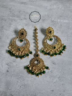 Overview Elevate your style with our stunning Green Maang Tikka and Earrings set, perfect for weddings, parties, and special occasions. This exquisite set is designed to make you feel special and stand out in any crowd. Shop now at Emro Collection! Product Features Elegant Design Our Green Maang Tikka and Earrings set features a sophisticated design that combines traditional elements with modern flair. The intricate detailing and vibrant green color make it a standout piece. High-Quality Materia Eid Party Tikka With Latkans, Festive Green Chandelier Earrings For Party, Green Bridal Earrings For Party And Festivals, Green Bridal Earrings For Party, Hand Set Chandelier Earrings For Parties And Festivals, Dangle Earrings For Eid Party, Green Bollywood Bridal Earrings For Party, Bollywood Style Green Bridal Earrings For Party, Diwali Party Hand Set Bridal Earrings