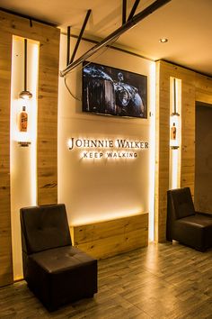 a lobby with two chairs and a sign on the wall that says john wayne walker keep walking