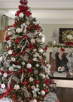 a decorated christmas tree with red and silver ornaments