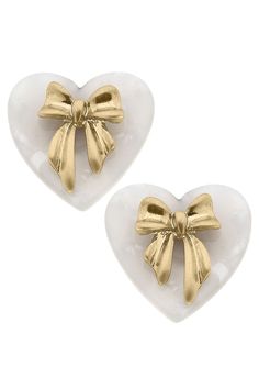 Complete your elegant look with our Cecelia Bow & Mother of Pearl Heart Stud Earrings. These stunning earrings feature a delicate bow design and a heart-shaped Mother of Pearl stone for a touch of sophistication. Perfect for any occasion, these earrings will make you stand out in style. Elegant Heart Pendant Earrings For Party, Elegant Heart Earrings For Party, Chic Heart Drop Earrings For Anniversary, Chic Heart Shaped Drop Earrings For Anniversary, Elegant Heart-shaped Earrings For Gifts, Elegant Heart Shaped Earrings For Gift, Chic Anniversary Heart Drop Earrings, Heart-shaped Earrings With Bow For Gift, White Bow Earrings For Anniversary