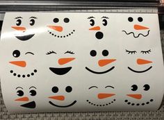 a close up of a paper bag with snowmen on it and faces drawn on the side