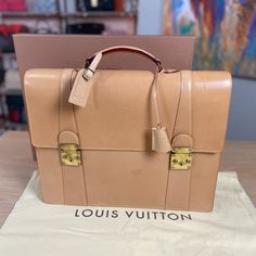 Louis Vuitton 100% Guaranteed Authentic Made In France Briefcase In Tan Vachetta Leather Includes Luggage Tag And Clochette With Keys + Box And Dust Bag By Louis Vuitton *Dust Bag & Box May Show Light Wear Retail Above $6k Ebay Will Authenticate This For You As A Complementary Service Before You Receive It And Will Also Provide You With A Heavy Weight Luxurious Ebay Dust Bag. Rare And Highly Collectible Louis Vuitton Tan Vachetta Leather Briefcase. Crafted From Luxurious Cowhide Vachetta Leather That Develops A Rich Patina Over Time, It Features Exquisite Brass Hardware And Meticulously Designed Compartments. Ideal For The Successful Businessman Who Values Timeless Elegance And Sop Luxury Cognac Briefcase For Formal Occasions, Brown Briefcase With Gold-tone Hardware For Business, Brown Business Briefcase With Gold-tone Hardware, Luxury Cognac Briefcase, Luxury Brown Briefcase With Gold-tone Hardware, Designer Brown Briefcase With Gold-tone Hardware, Luxury Satchel Cases For Formal Occasions, Designer Formal Briefcase With Palladium Hardware, Luxury Brown Formal Cases