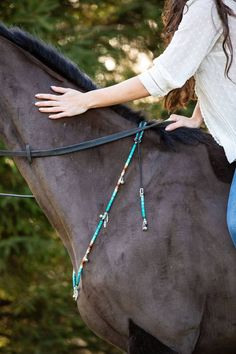 a woman riding on the back of a brown horse