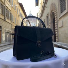 This bag has been made of the best genuine leather by local master crafters of Florence in Italy, designed for women who only accept premium Italian quality and luxury leather bags and modern Italian fashion. . Sizes: Width: 29cm/10.6 inch Height: 19cm/7.4 inch Depth: 7 cm/3.9 inch Color: Black . The story of this bag:  John was visiting Florence with his family and he wanted to find the perfect gift for his wife and daughters. He had heard about the exquisite leather craftsmanship in the city a Leather Box Bag With Detachable Handle For Daily Use, Luxury Black Satchel With Leather Lining, Leather Shoulder Flap Bag With Top Carry Handle, Black Leather Backpack With Top Handle, Black Briefcase With Detachable Handle, Luxury Black Leather Bag, Black Top Handle Flap Bag For Daily Use, Leather Backpack With Top Handle, Elegant Leather Backpack With Top Carry Handle