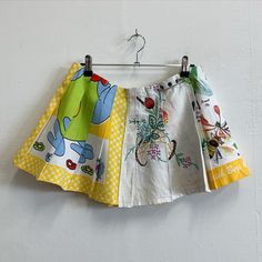 three different colored shorts hanging on a white wall