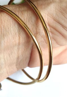 Bangle bracelet, gold bangle bracelet for women, gold bracelet, minimalist bracelet, basic bangle, stacking bracelets, simple gold bracelets A minimalist, gold bangle bracelet, simple but chic, created from a 2.5mm wire which was soldered and plated with nickel free, 14k gold plating. The bangle can be worn by itself or stacked together with similar or different bangles in my shop. These stacking bangle bracelets are a perfect gift for teens and women. Dimensions: The gold bangle bracelet is 2.5mm thick (0.1 inches) and is available in 3 different sizes: Small (S), Medium (M) and Large (L). Small - diameter of 6 cm (or 2.35 inches) Medium - diameter of 6.3 cm (or 2.5 inches) Large - diameter of 7 cm (or 2.75 inches)  Can be made in different sizes upon request. Just convo me for pricing. T Minimalist Gold Hoop Bracelet, Minimalist Yellow Gold Brass Bangle, Gold Hoop Bangle In Minimalist Style, Minimalist Gold Stackable Hoop Earrings, Minimalist Gold Bangle Cuff Bracelet, Minimalist Gold Hoop Bangle, Minimalist Everyday Brass Bangle, Minimalist Yellow Gold Hoop Bracelet, Everyday Minimalist Brass Bangle