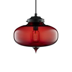 a red glass pendant light hanging from a ceiling fixture with a black cord attached to it