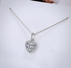 Delicate and elegant, this heart necklace will add a touch of sophistication to any wedding gown or formal ensemble. Adorned with heart-shaped cubic zirconia that captures the light from every angle with a perfectly translucent appeal, the necklace is rhodium / rose gold plated for a flawless finish which perfectly enhances the intricate detailing and conveys a modern take on old elegance. Length: 16" (approx. 40.6cm) with a 2" (approx. 5cm) extension for comfortable sizing. Available in Silver