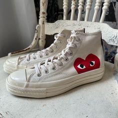 Wear Your Heart On Your Shoes With The Converse X Comme Des Garons Play Chuck 70 Sneaker. This Street-Ready Style Features The Premium Chuck Details You Know And Love, Paired With A Whimsical Heart-And-Eyes Graphic Peeking Just Above The Sole. Eye-Catching Is An Understatement. Why You Should Be Down: -Canvas Is Lightweight And Durable. -Tonal Rubber Toe Cap And Contrasting Heelstay For Standout Style. -Lace-Up Design For A Snug Fit. -Vulcanized Rubber Sole For Increased Traction. -Signature Hea Cgd Hearts, Casual Custom Sneakers With Red Sole And Round Toe, Converse Custom Sneakers With Gum Sole And Round Toe, Flat Sneakers With Red Sole For Streetwear, Casual Custom Sneakers With Red Sole, Canvas Sneakers With Red Sole And Round Toe, Custom Converse Sneakers With Gum Sole And Round Toe, Custom Canvas Low-top Sneakers, Casual Canvas Sneakers With Red Sole