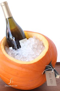 a bottle of wine sitting in an orange bowl filled with ice