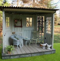 a doll house with furniture and accessories on the porch in front of an open door