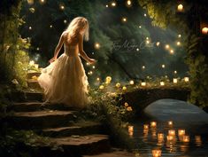 a woman in a white dress is standing on some steps by the water with candles