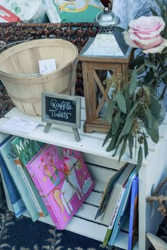 there is a wooden basket on top of a shelf with greeting cards and flowers in it