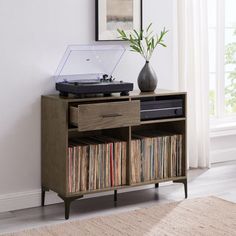 a record player sitting on top of a wooden cabinet