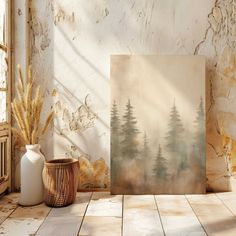 a painting sitting on top of a wooden floor next to a vase and potted plant