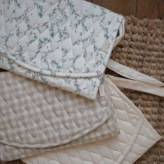 three mattresses laying on top of each other next to a wooden floor and wall