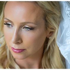 a beautiful blonde woman wearing a white veil