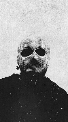 a black and white photo of a person wearing a mask