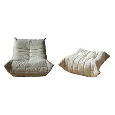 two white pillows sitting next to each other