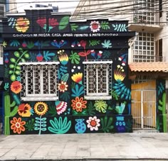 a colorful building painted with flowers and plants