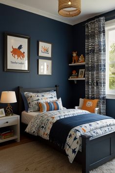 a bedroom decorated in blue and orange with pictures on the wall above the bed, along with two nightstands