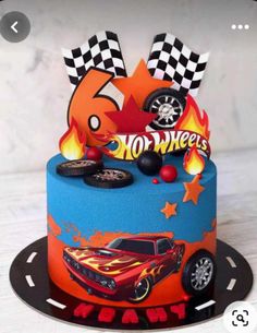 a birthday cake decorated with cars and flames