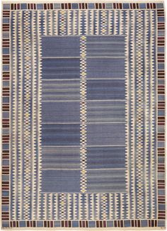 a blue and white rug with stripes on the bottom, two rows of lines in different colors