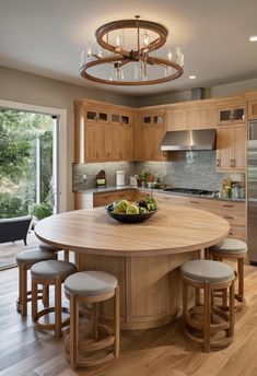 a large kitchen island with stools around it and a bowl of fruit on the counter