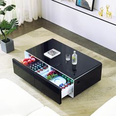 a coffee table with an open drawer underneath it