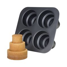 a cake pan with six cupcakes in it next to a wooden holder that holds four cups