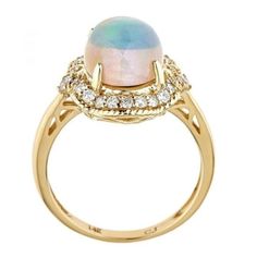 Give her this unique, regal jewelry from Gin & Grace. A colorful display and chic design showcases Natural opal gems and glistening diamonds. The pretty ring is gleaming and made of 14k yellow gold. Gemstone colors: White Gemstone shapes: Oval-cut One prong-set Oval-cut Natural Opal measures 9 mm wide x 11 mm long Gemstone weight: 2 1/10 carats Total gemstone weight: 2 1/10 carats Diamonds: 24 Diamond cut: Round Diamond measurements: Each measures 1 mm Diamond weight: 1/3 carat Color: G-H Cl Elegant Gold Opal Cabochon Ring, Elegant Opal Cabochon Ring, Elegant Ethiopian Opal Cabochon Rings, Luxury Gold Multi-stone Opal Ring, Elegant Ethiopian Opal Cabochon Jewelry, Elegant Ethiopian Opal Jewelry With Cabochon, Elegant Multi-stone Opal Jewelry, Elegant Ethiopian Opal Jewelry With Gemstone Accents, Elegant Ethiopian Opal Ring With Oval Cabochon