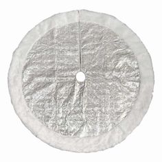 a white round object with silver foil on the top and bottom part of it, in front of a white background