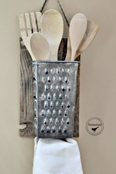 wooden spoons and spatulas in a metal grater with a quote about kitchen utensils