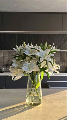 a vase filled with white flowers on top of a table