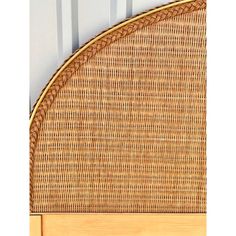 the headboard is made out of wicker and has an oval design on it